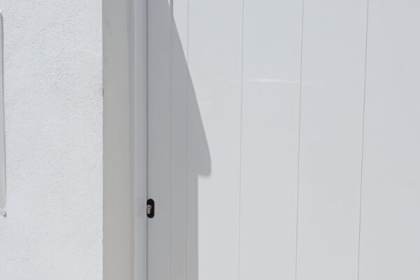 Puerta de entrada de aluminio abatible con duelas. Proyectos de aluminio a medida.